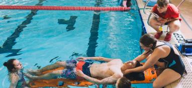 Pulling man from pool in lifeguard training