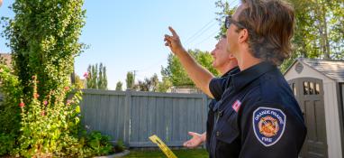 Photo of Grande Prairie Fire Department staff engaging with a homeowner
