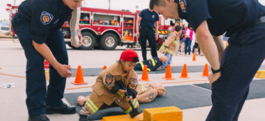 Two firefighter teaching a small child