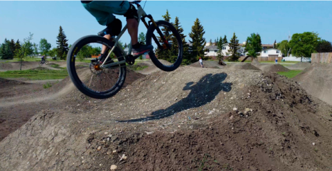 Person biking over hill